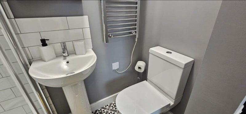 A modern bathroom with a clean white sink and t...