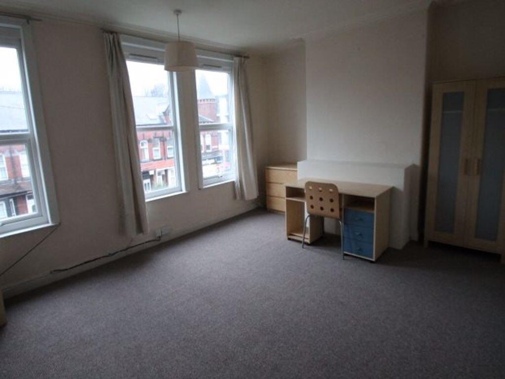 A clean, well-lit room featuring three large wi...