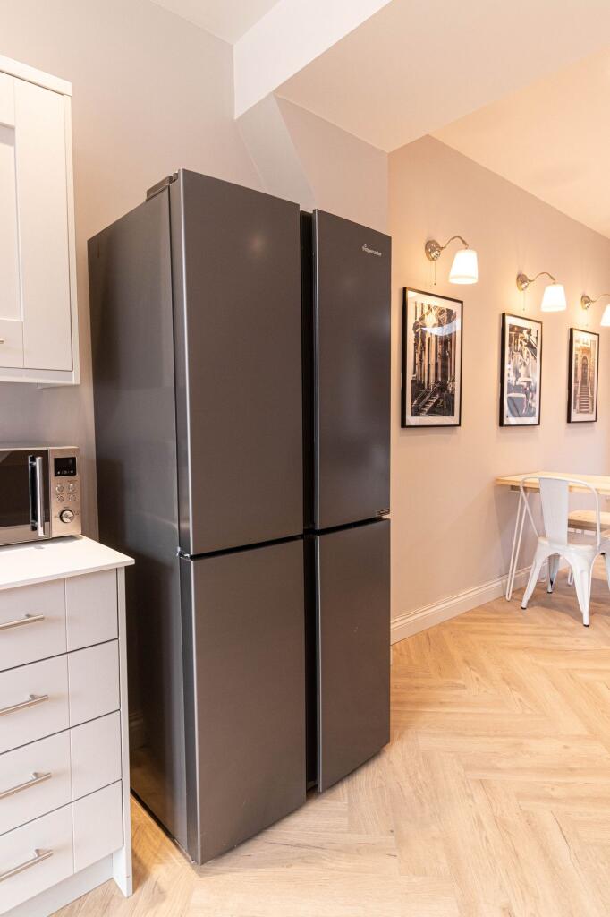 Modern kitchen with sleek grey appliances, incl...