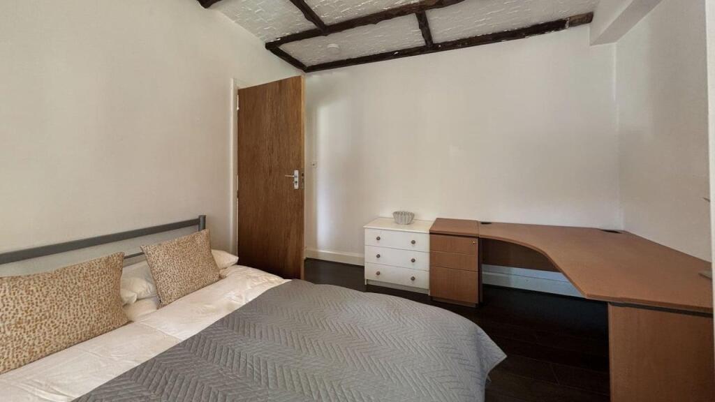 Cozy bedroom featuring a double bed with decora...