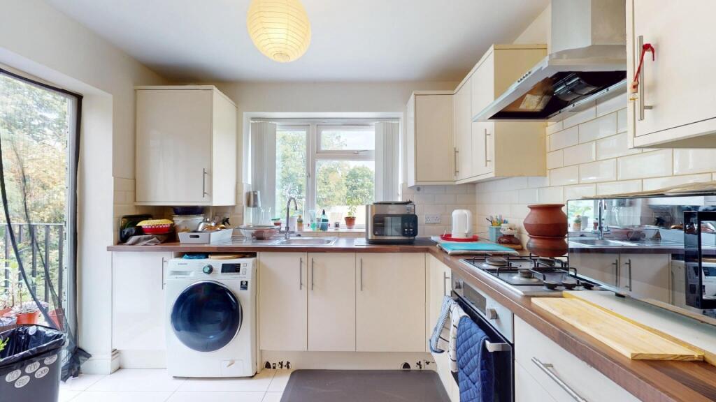 Bright and modern kitchen with ample natural li...