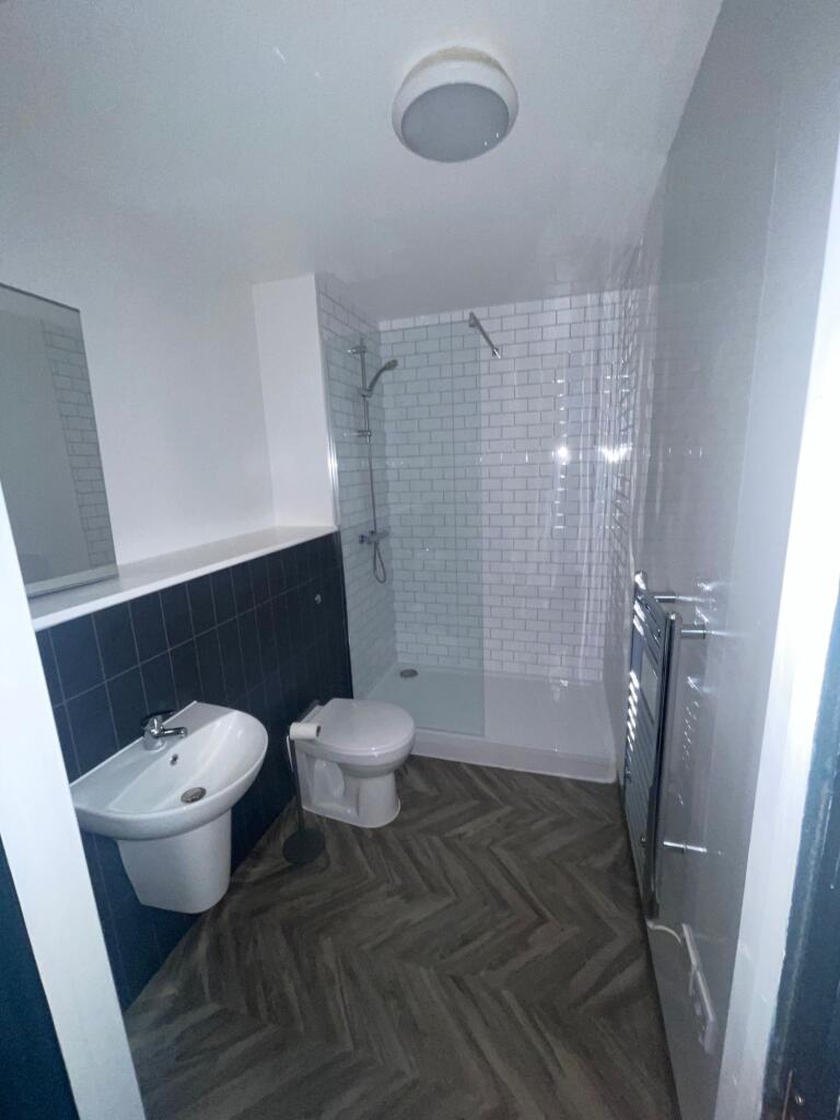 A modern bathroom featuring a walk-in shower wi...