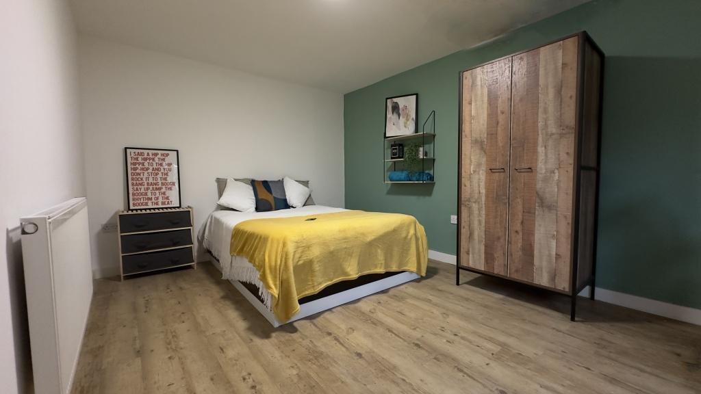 A bright and welcoming bedroom featuring a mode...