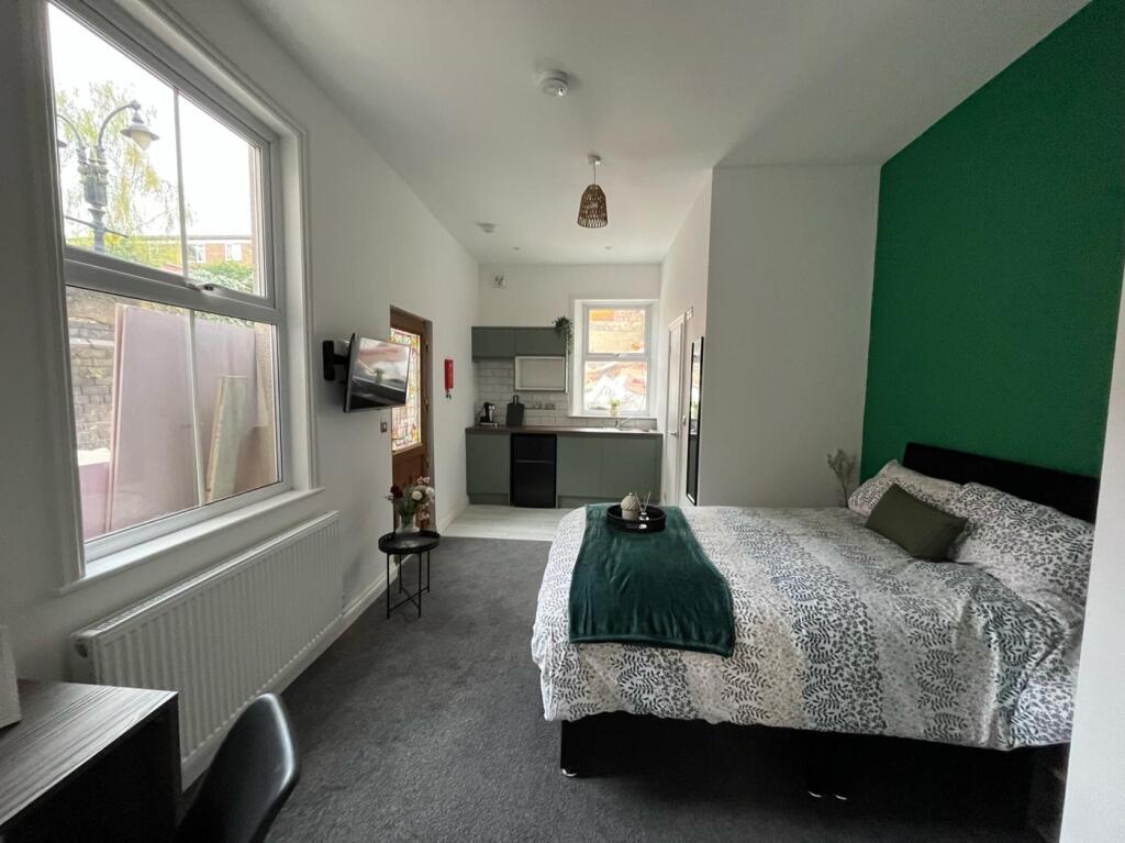 Spacious double bedroom featuring a comfortable...