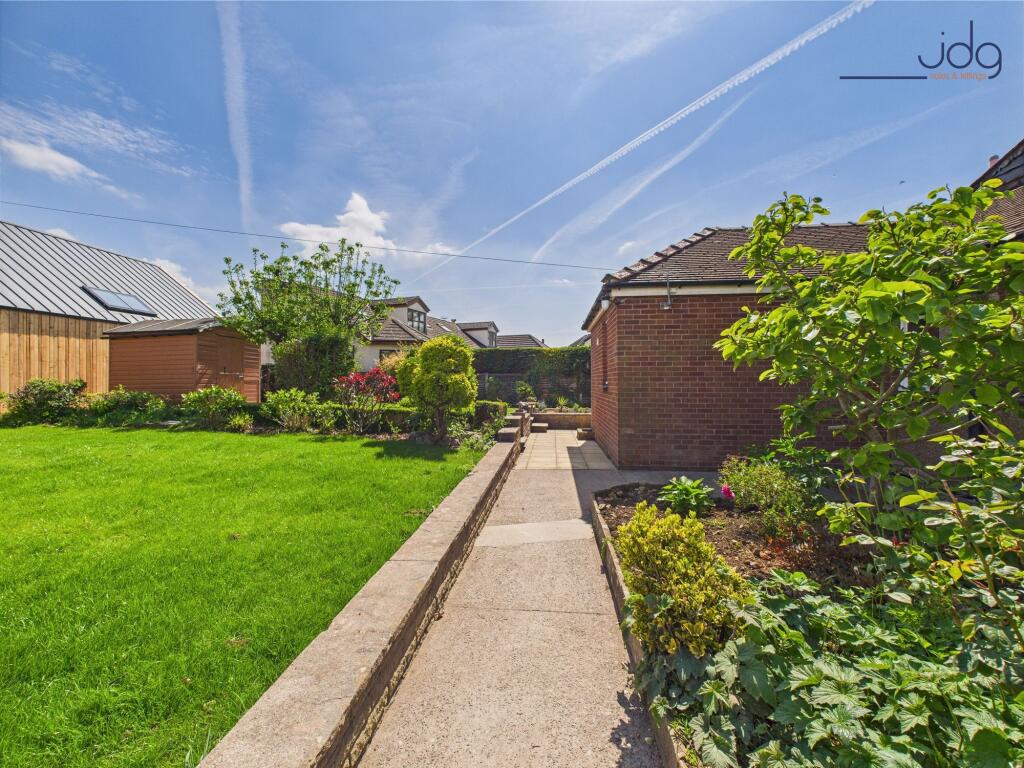 Mature gardens that extend to the front of the driveway