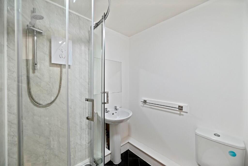 Bright and clean modern bathroom featuring a co...