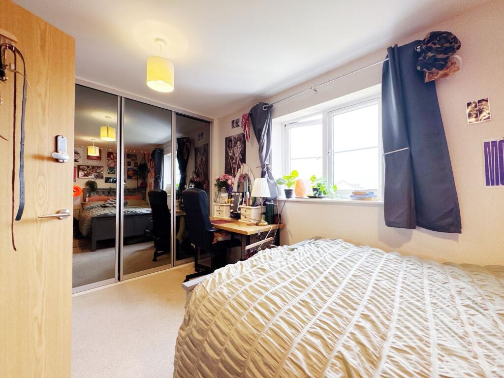 Bright and inviting living room with large wind...