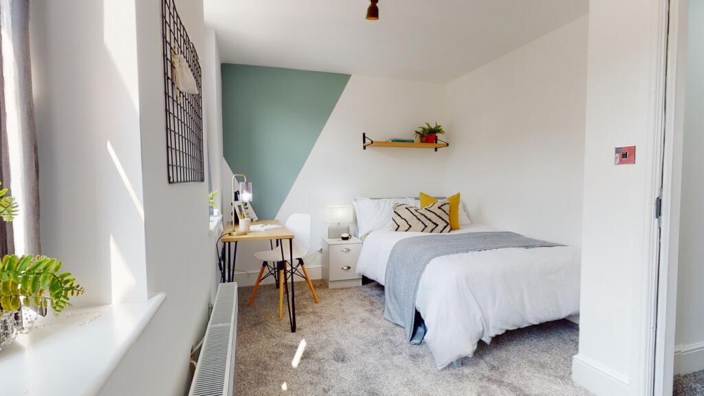 A bright and inviting double bedroom featuring ...