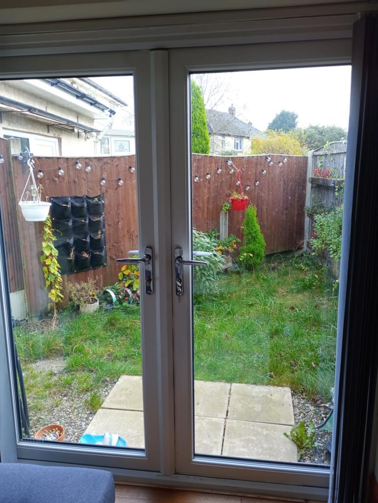A cozy garden area viewed through double glass ...