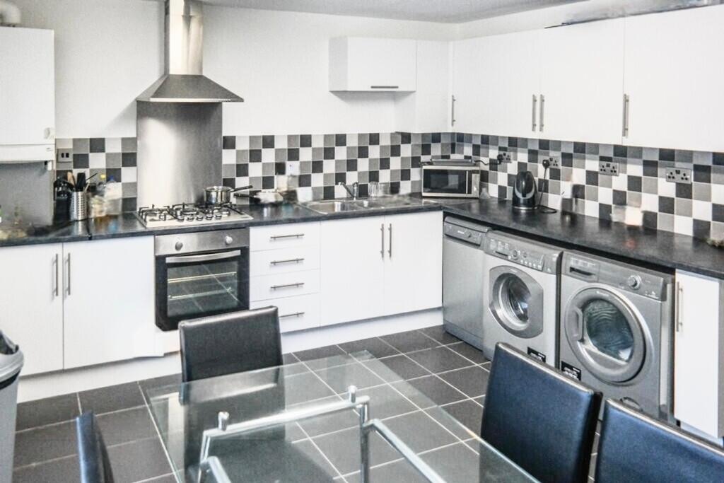 Modern kitchen featuring sleek cabinetry, ample...