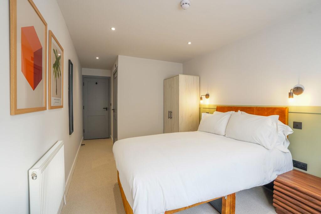 A spacious and inviting master bedroom with a c...