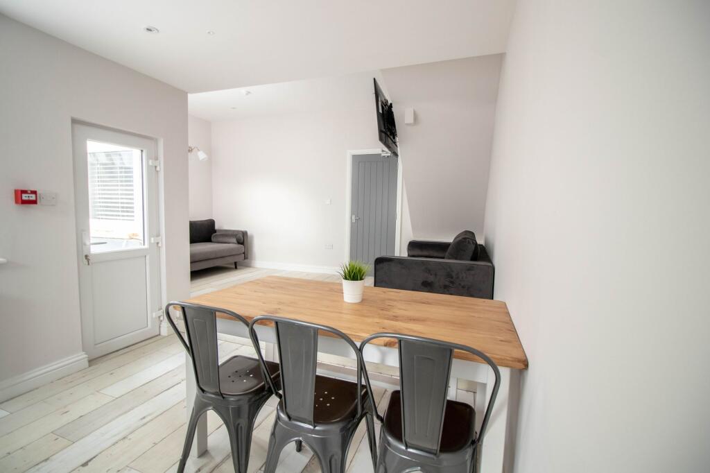 Bright and modern living room featuring a comfo...