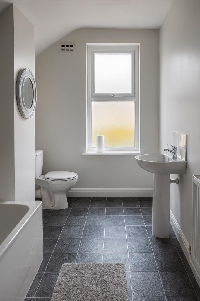 Bright and tidy bathroom featuring a large fros...