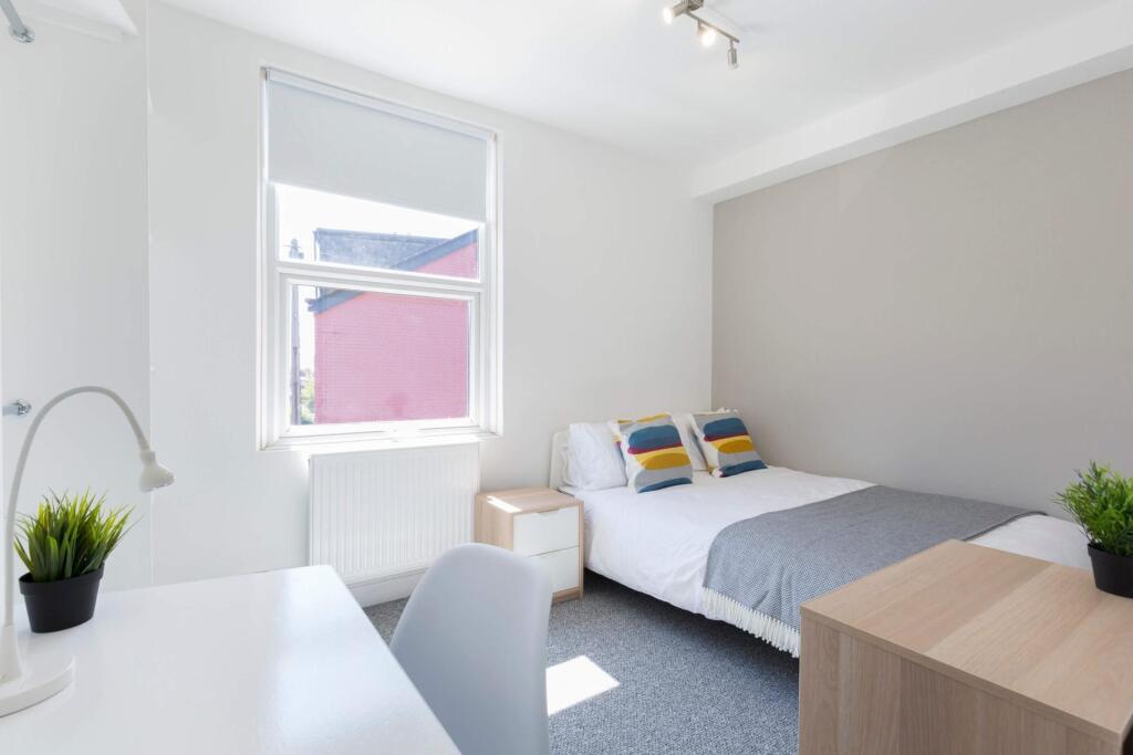 Bright and modern master bedroom featuring a sp...