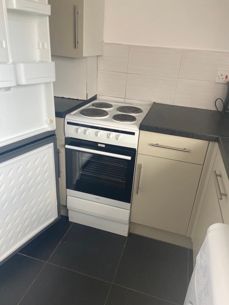 A bright and tidy kitchenette with modern appli...