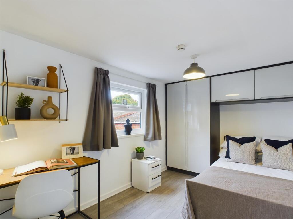 A bright and modern double bedroom featuring a ...