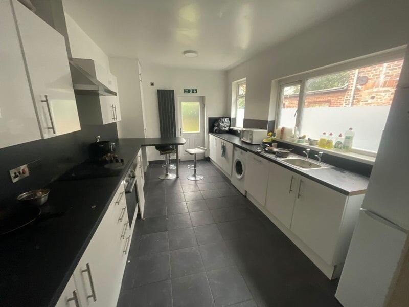 Bright and practical kitchen featuring modern w...