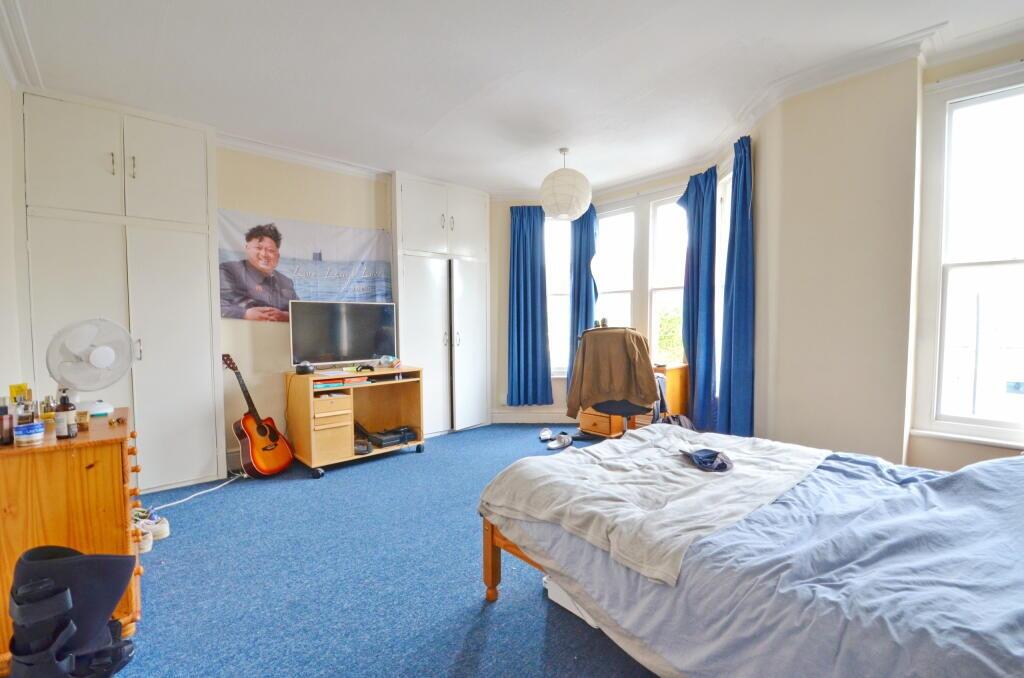 Spacious and bright master bedroom featuring a ...