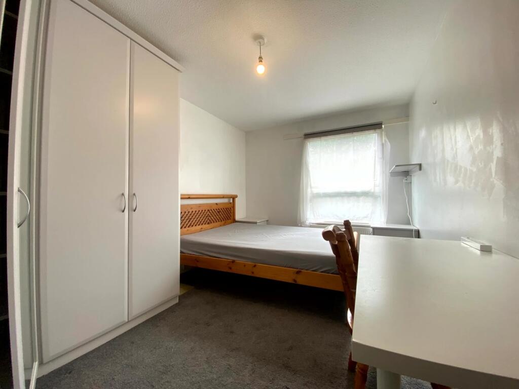 A spacious and well-lit double bedroom featurin...