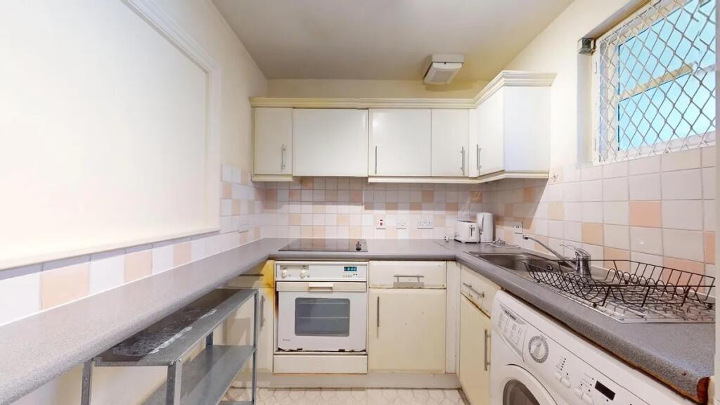 Bright kitchen with ample countertop space and ...