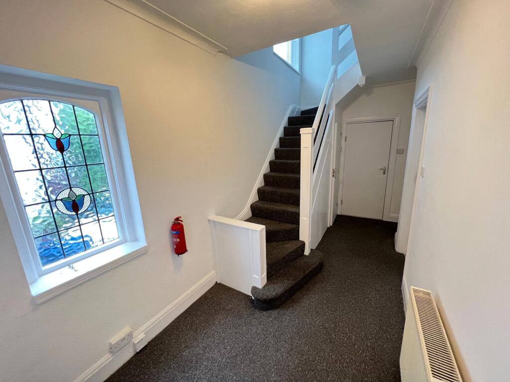 A clean and well-maintained hallway featuring a...