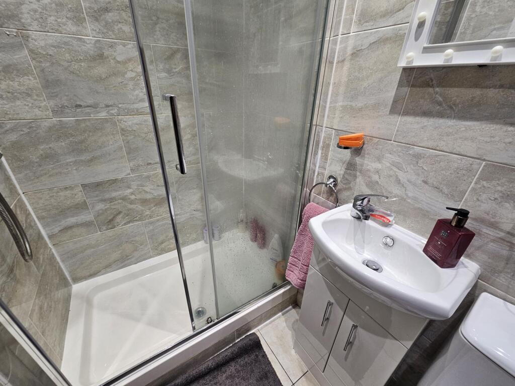 A clean and modern bathroom featuring a spaciou...