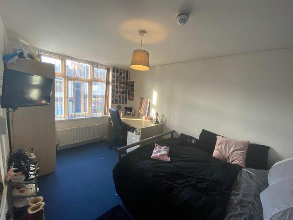 A spacious and inviting double bedroom filled w...