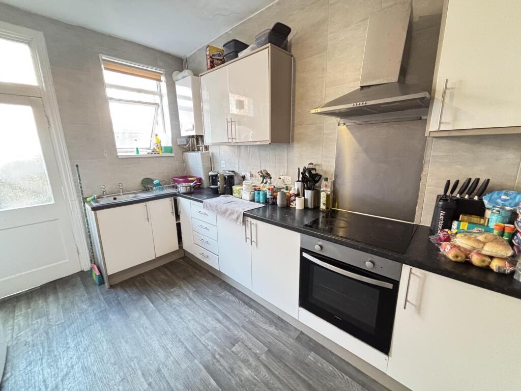 A well-maintained kitchen featuring modern cabi...