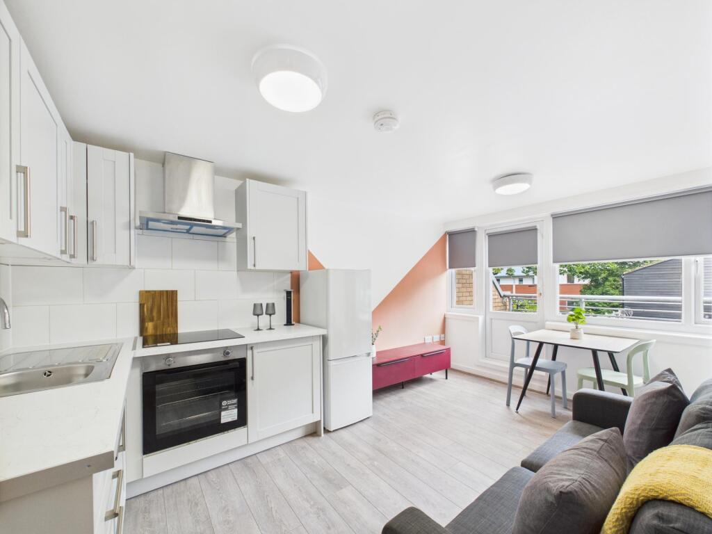 Bright open-plan living area with a modern fitt...