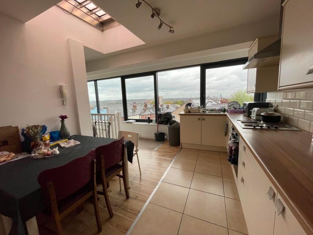Bright kitchen space featuring a long counterto...