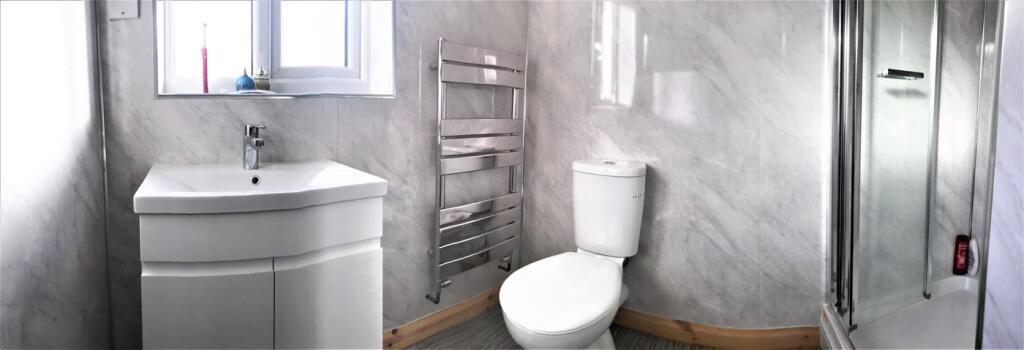 Modern bathroom featuring sleek fixtures and a ...
