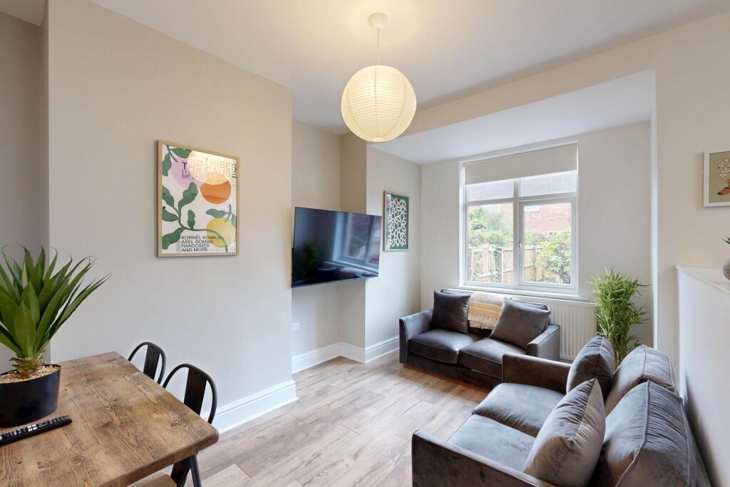 A bright and welcoming living room featuring co...