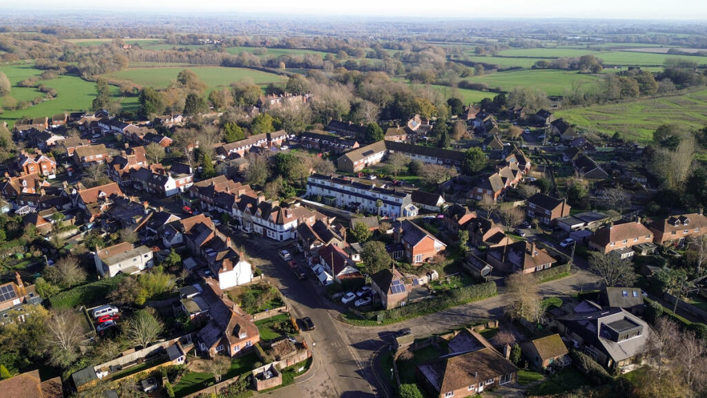 Aerial view over the house and open countryside and walks beyond