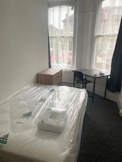 A bright single bedroom with large bay windows ...