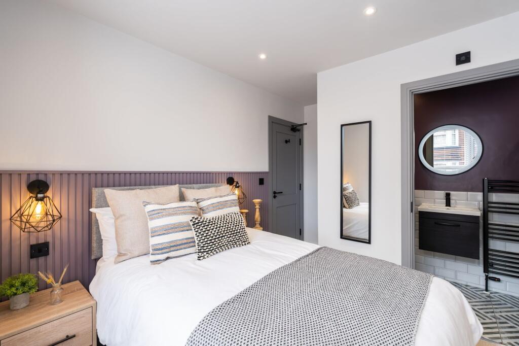 Modern and cozy bedroom featuring a comfortable...