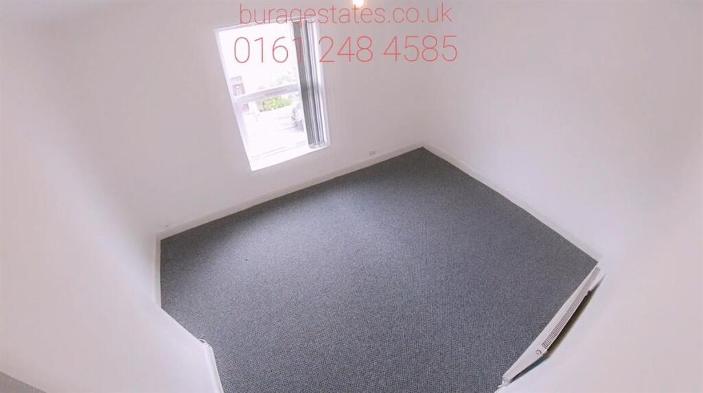 A bright, clean single bedroom with carpeted fl...