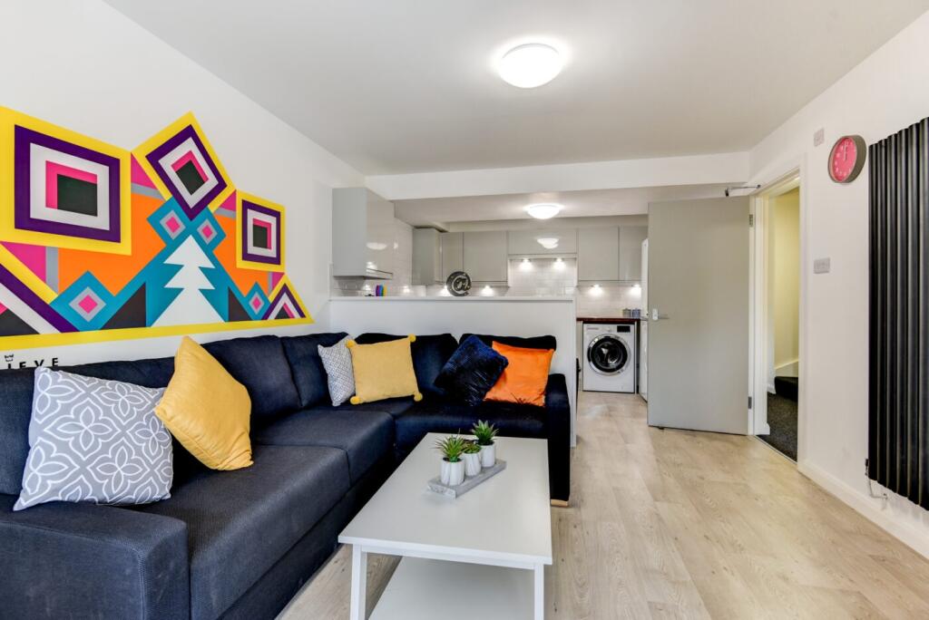 Bright, modern open-plan living area with a lar...