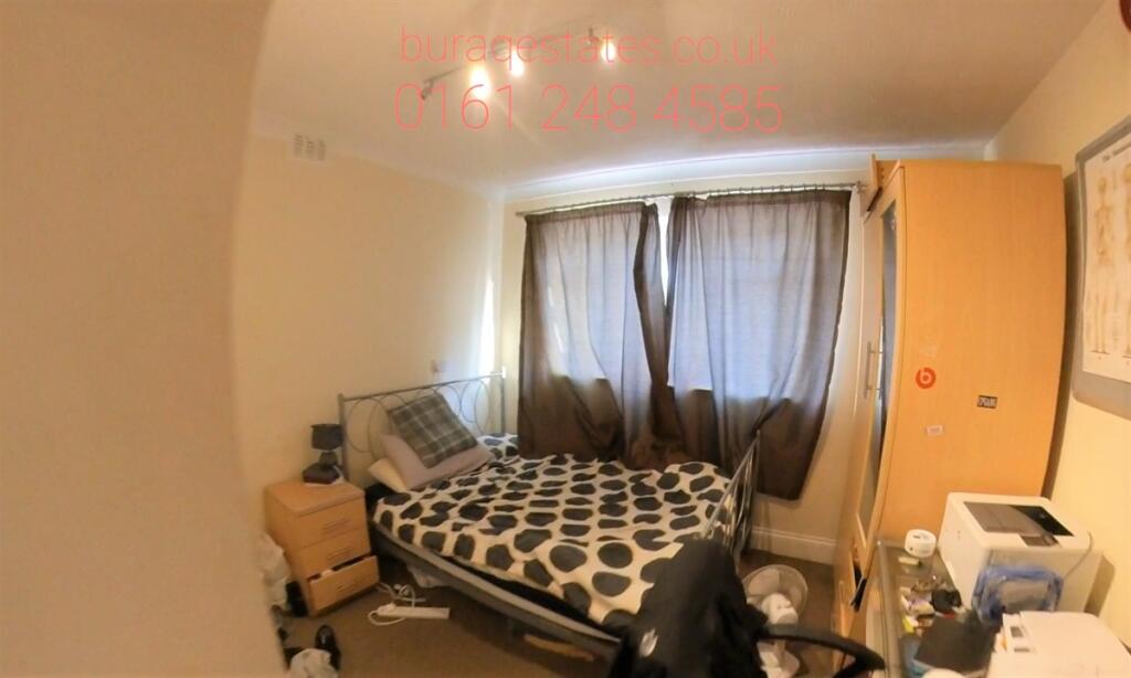 Cozy bedroom with a patterned double bed, soft ...