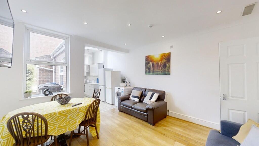A bright and airy living room with large window...