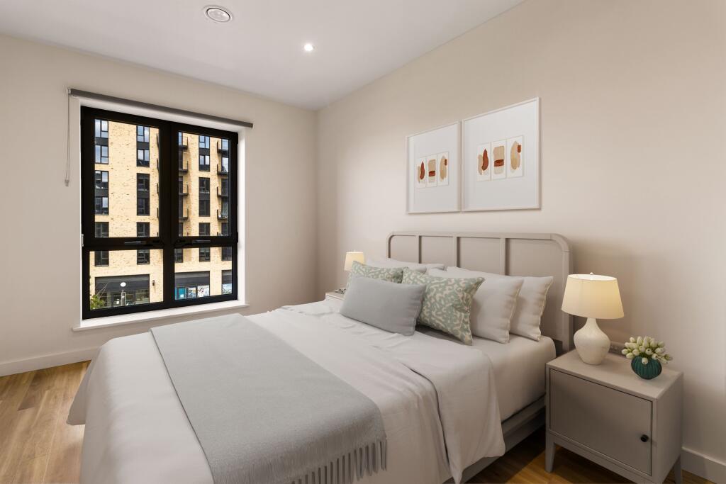 Experience serene mornings in this bright and chic city bedroom.