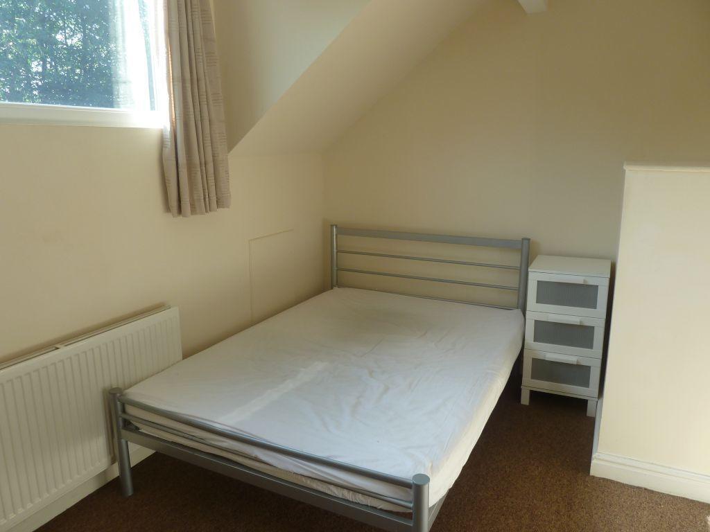 A simple and neat single bedroom featuring a me...