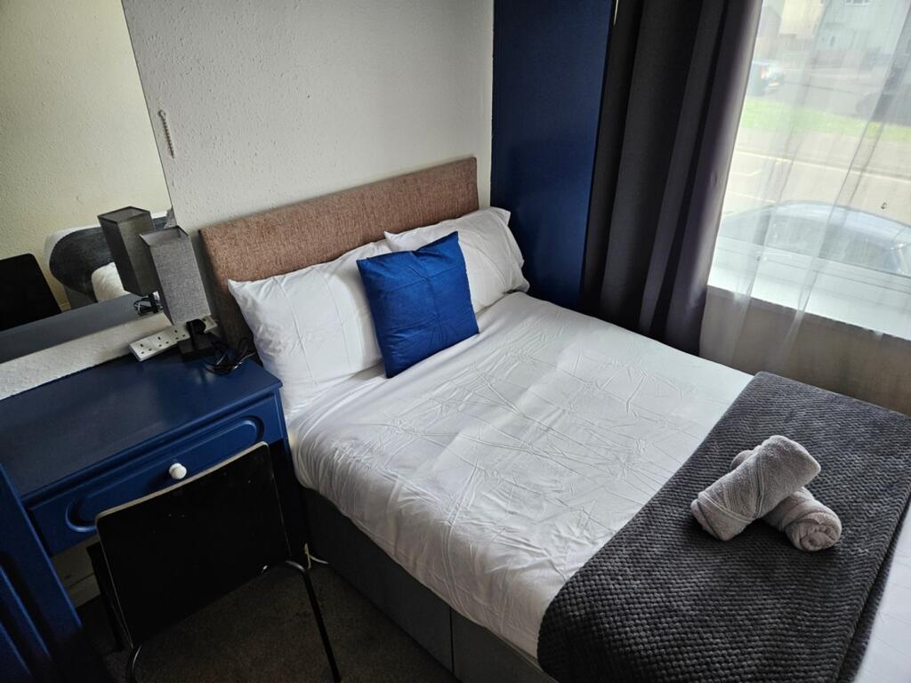 A bright and tidy double bedroom featuring a co...