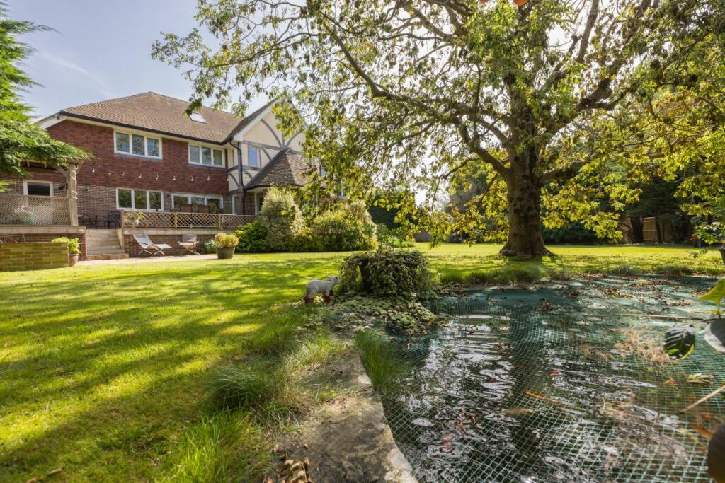 View of pond and rear of home