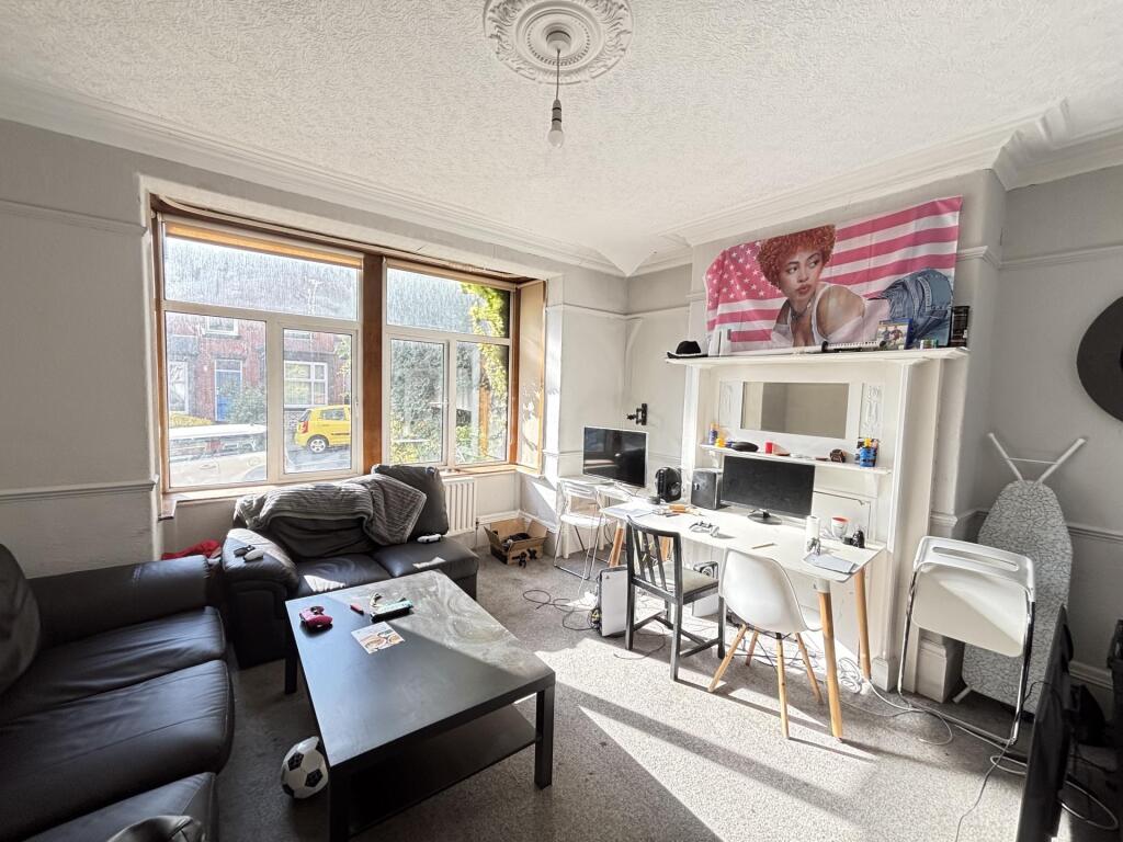 A bright and spacious living room featuring lar...