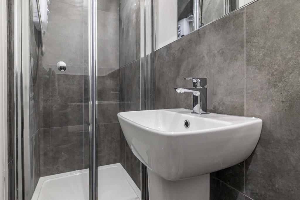 A clean and modern bathroom featuring a white s...