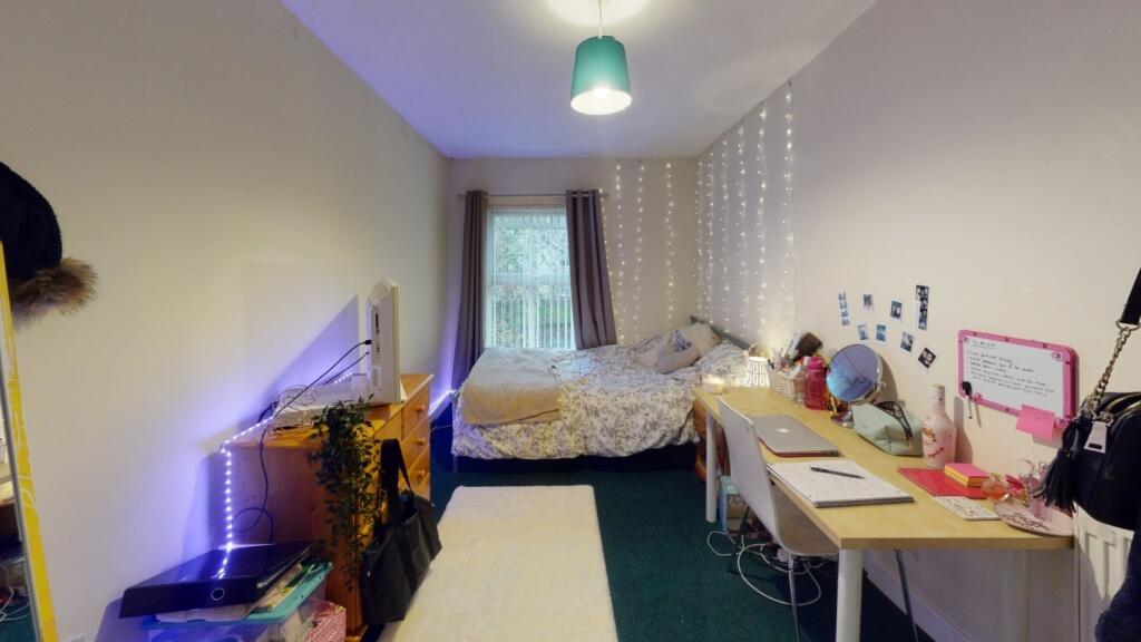 A cozy and well-organized single bedroom featur...