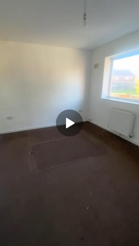 A bright, spacious living room with a large win...