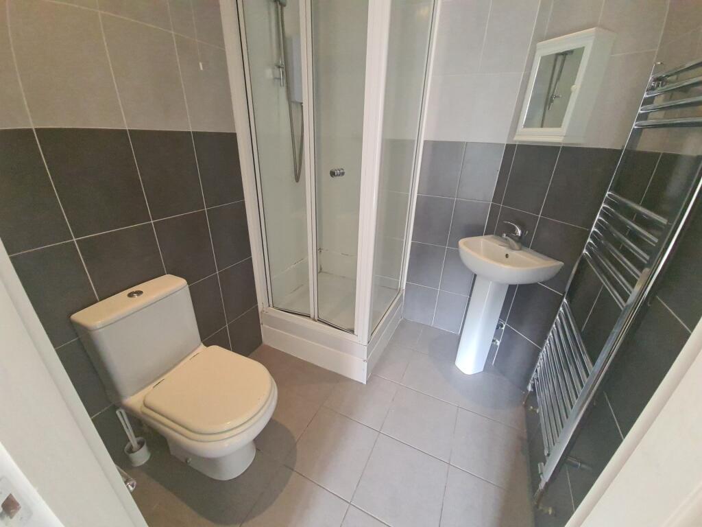 A bright and modern bathroom suite featuring a ...