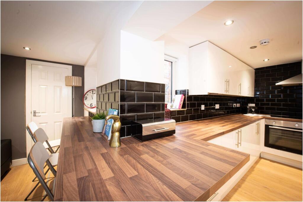 Modern and spacious living area featuring a sle...
