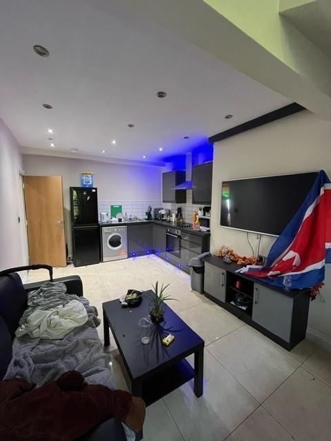A modern living room featuring a large flat-scr...